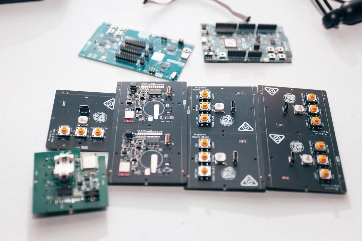 Early development boards and Skiparoo circuit boards arranged on the workbench