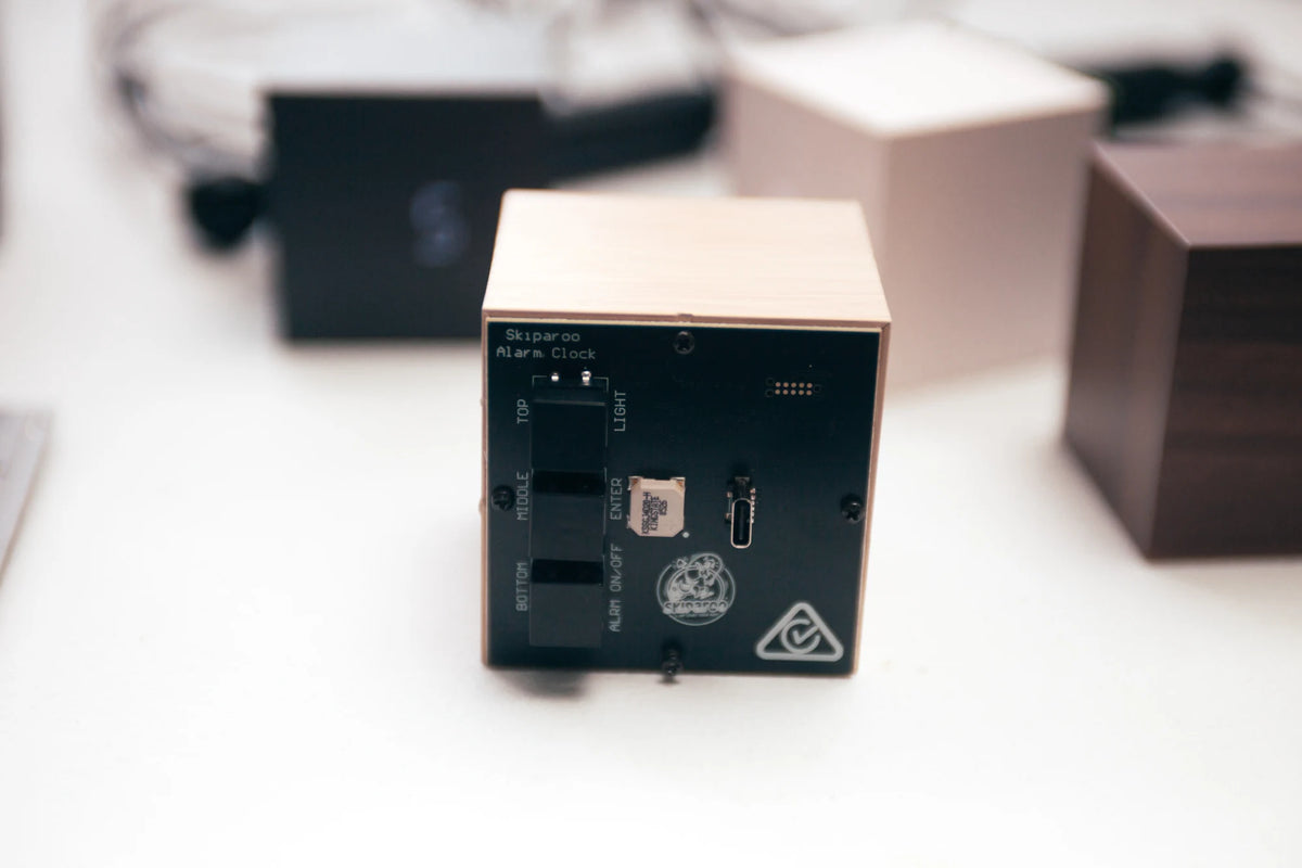 Close-up of the Skiparoo alarm cube's rear controls and USB-C port