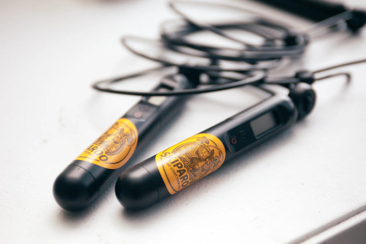 Two Skiparoo skipping rope handles with yellow branded labels